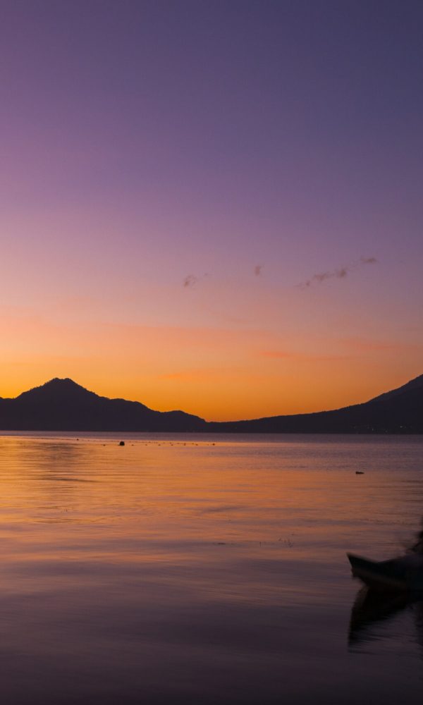 Sunrise in Atitlan, Solola, Guatemala, view of sunrise and reflections in the lake and mountains and volcanoes in the background.
